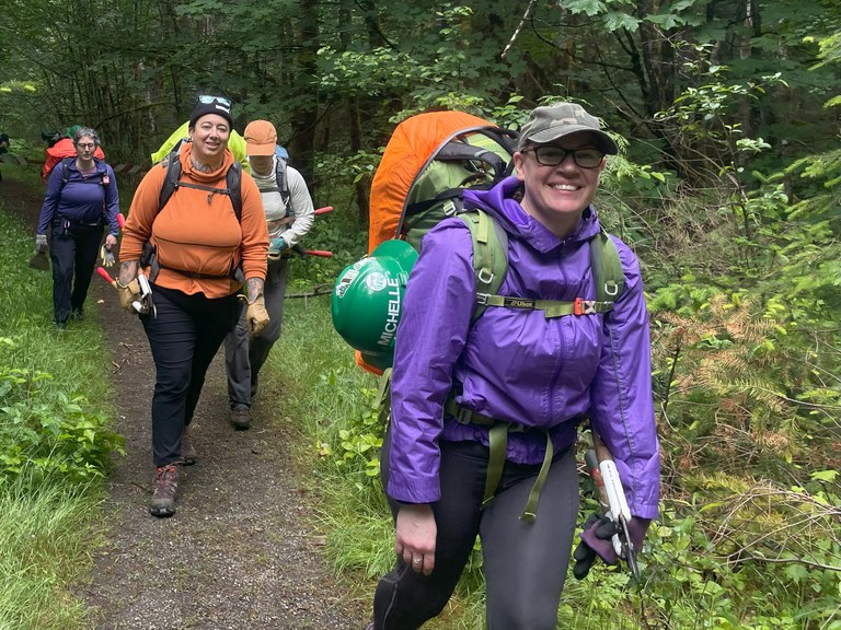 A BCRT crew. Photo by Elizabeth Storm. A BCRT crew hiking with tools and backpacks on the Dosewallips River Road trail. Photo by Elizabeth Storm.