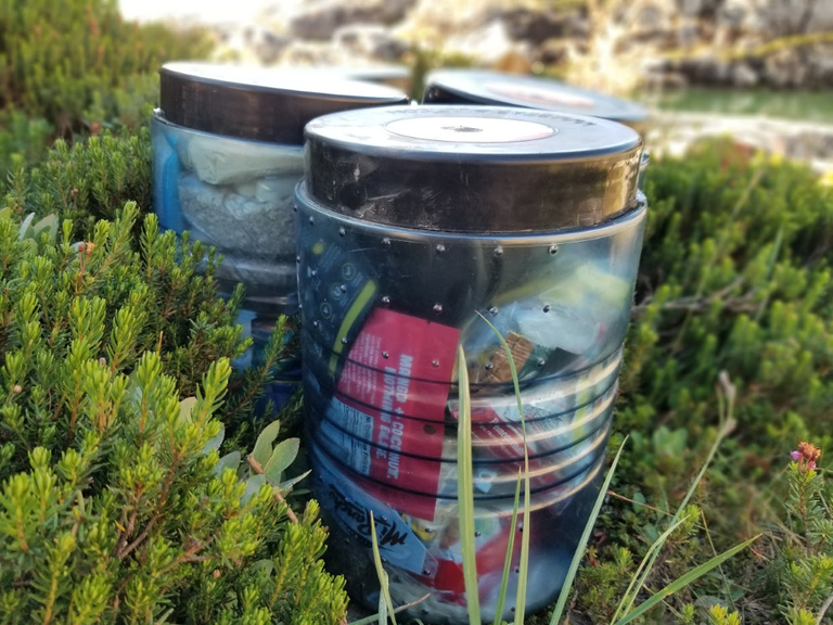 Bear canisters. Photo by Joseph Gonzalez. Bear canisters on the ground. Photo by Joseph Gonzalez.