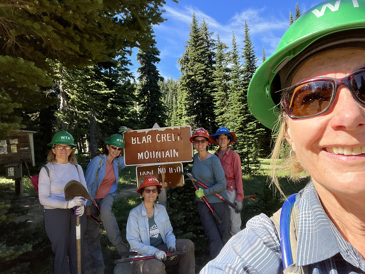 Group selfie posing at a Bear Creek Mountain trail sign. Photo by Suzanne Hartman.