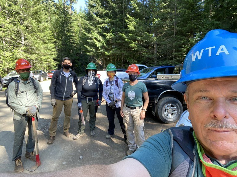 Volunteer Blue Hat Patrick Sullivan snaps a photo on trail with his crew.
