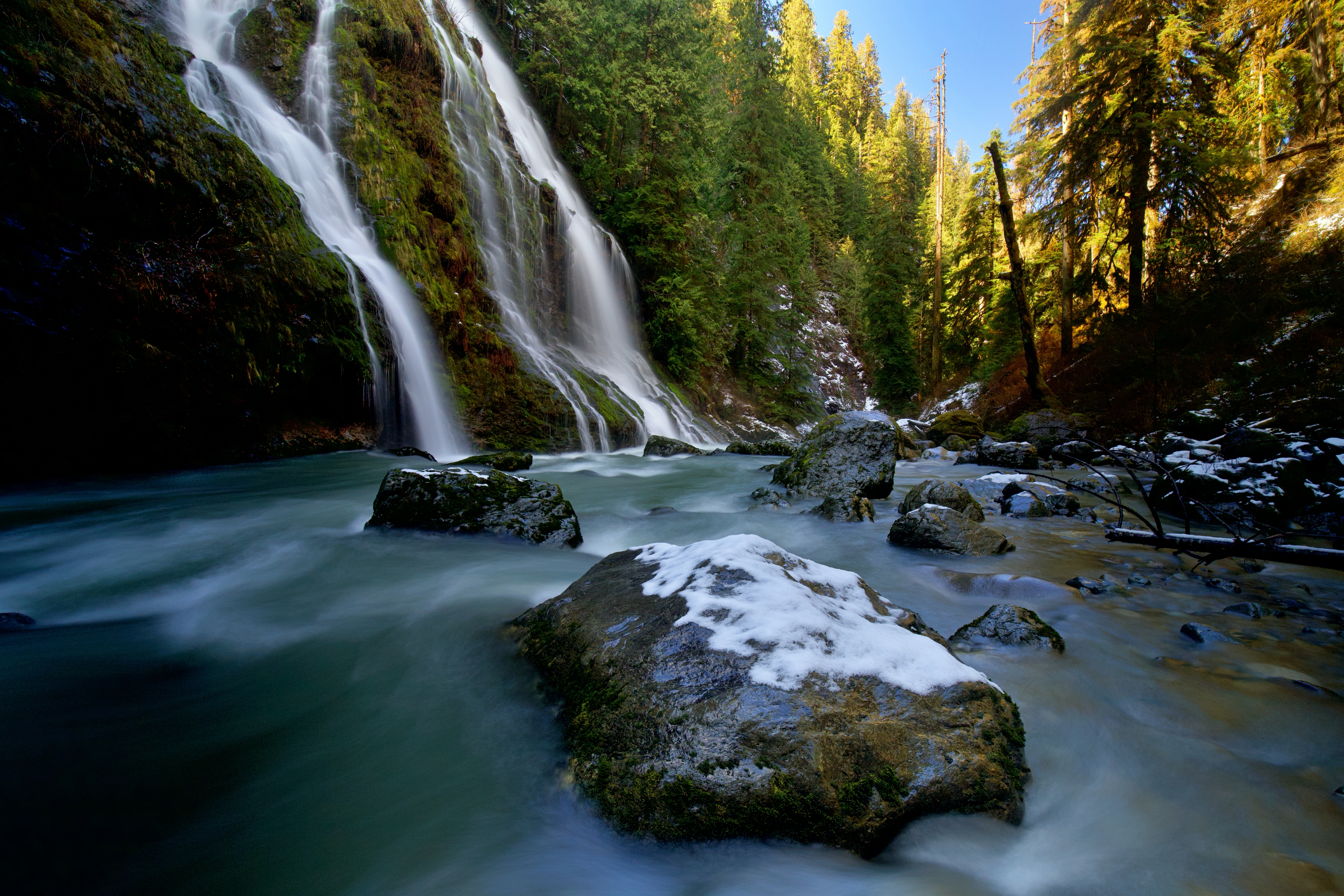 A late snowfall covers stones near the "Feature Show Falls" along the Boulder River Trail.