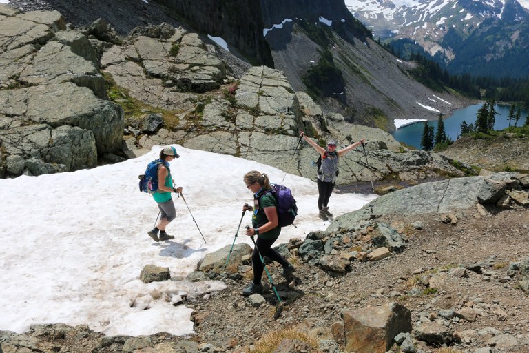 Hikers hiking on snow at Chain Lakes Loop