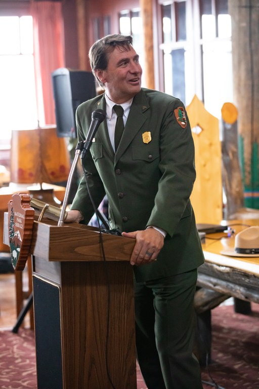 Chip Jenkins, Superintendent of Mount Rainier National Park. Photo by Kevin Bacher, NPS. Chip Jenkins, Superintendent of Mount Rainier National Park stands at a podium. Photo by Kevin Bacher.