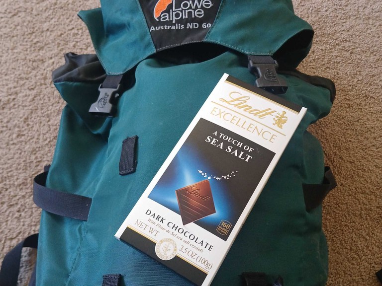 A bar of dark chocolate sitting on a backpacking pack. Photo by Melani Baker.