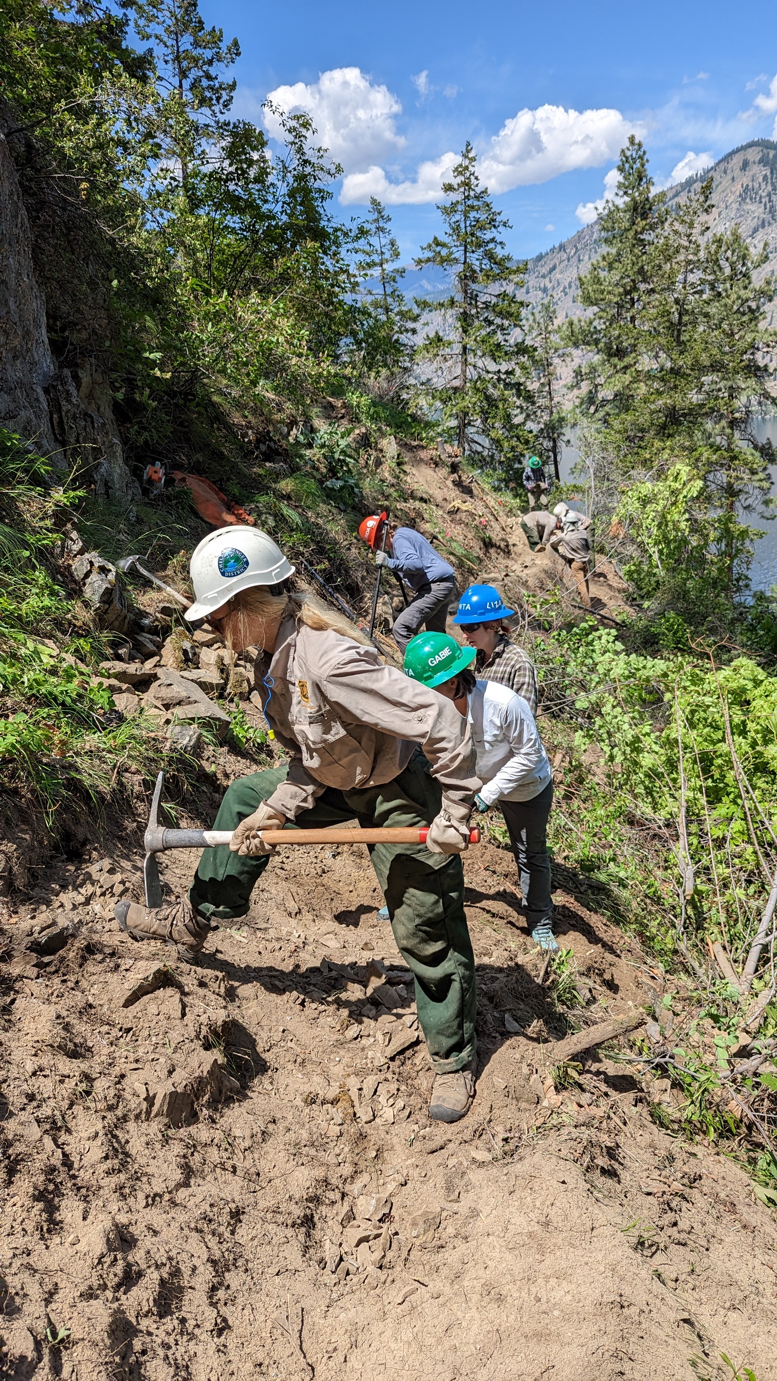 Forest Service staff on the Lake Chelan Lakeshore Trail works alongside WTA volunteer crew. Photo Dawn Rorvik. Forest Service staff on the Lake Chelan Lakeshore Trail works alongside WTA volunteer crew.