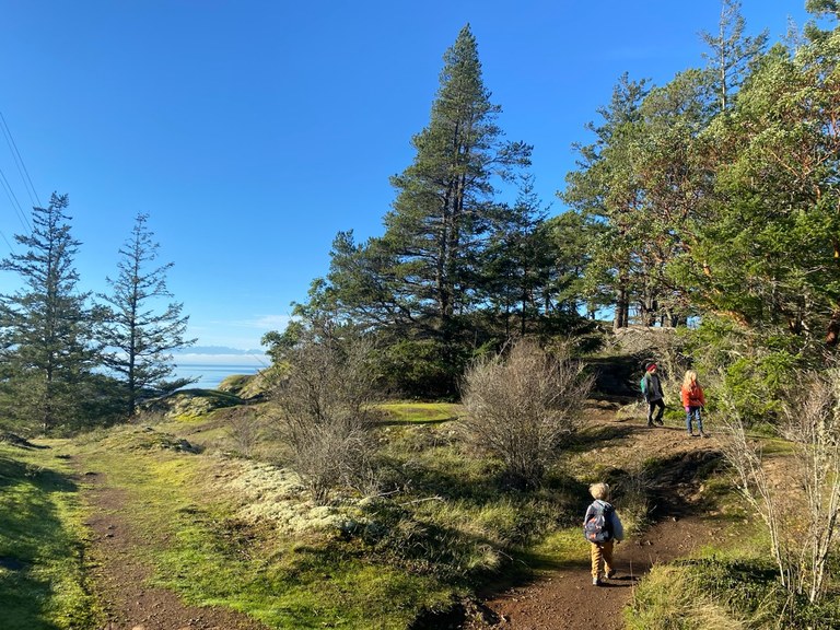 A few kids hike on the trail at Deception Pass State Park. Photo by Kjmorty.