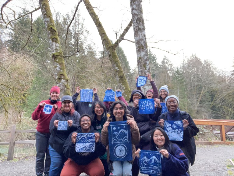 The 2025 WTA Emerging Leaders Program cohort with staff from Washington State Parks holding up batik dying pieces. Photo by Washington State Parks Director of Diversity and Inclusion Janette Chien.