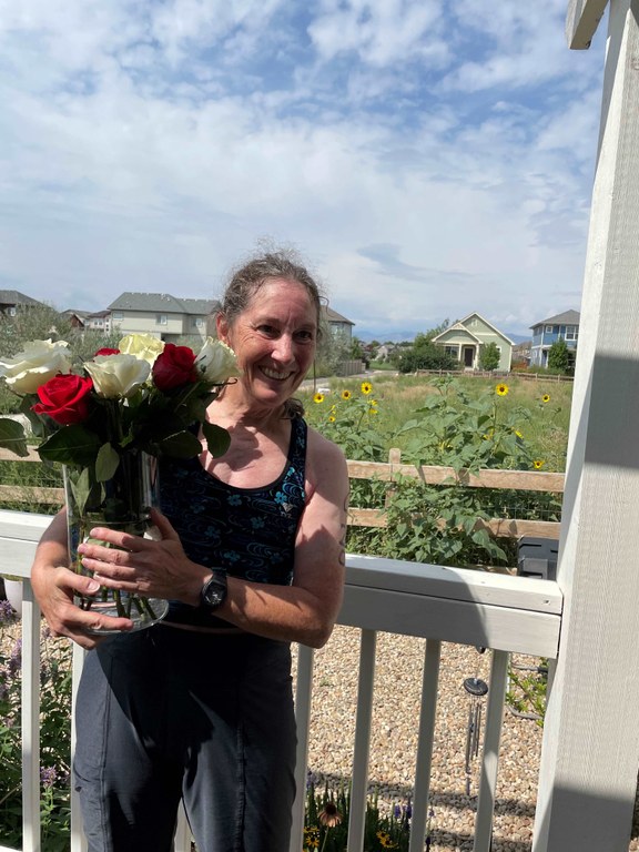 Erin's aunt, Kathie, with flowers after finishing her first triathlon post-stroke, 4 years later. Photo by Erin McMillin.