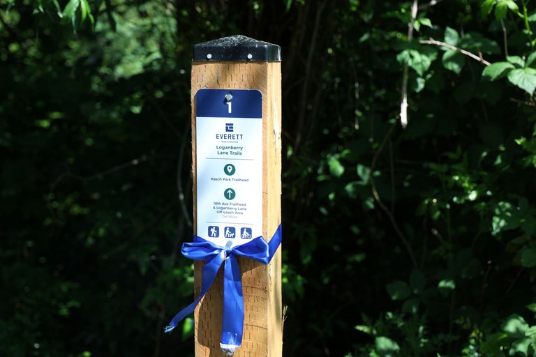 First wayfinding sign located near the Athletic Complex at Kasch Park with a ribbon around it. Photo by Victoria Obermeyer.
