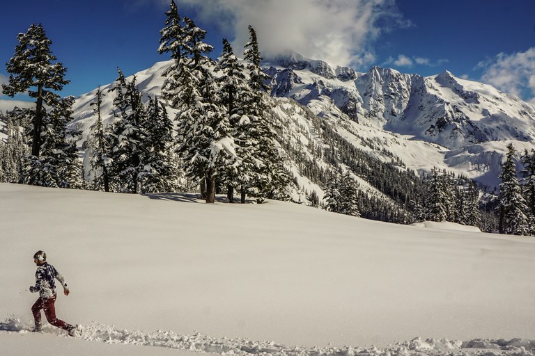 A man runs across a snow landscape. Photo by Mathew Leaman. 