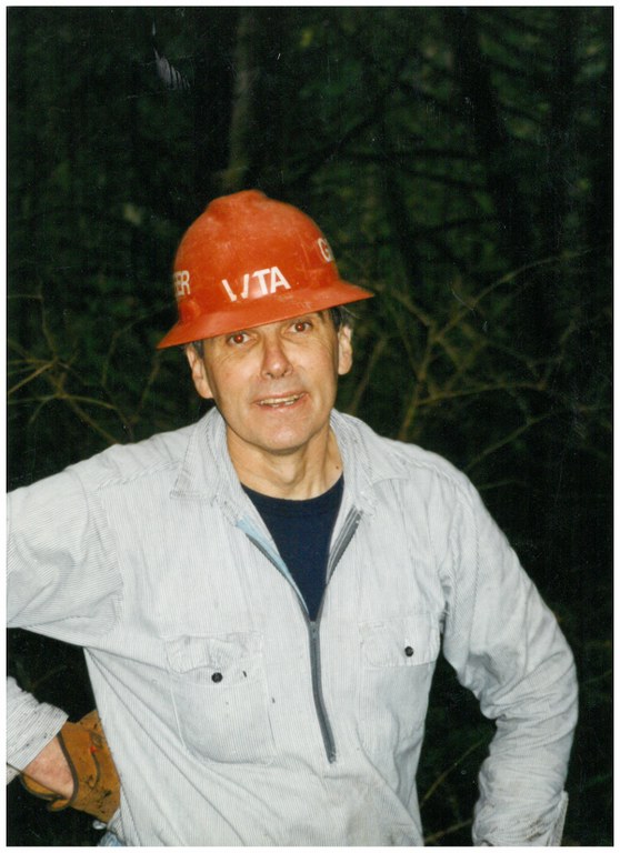 Greg Ball, wearing an orange hat, smiles at the camera.