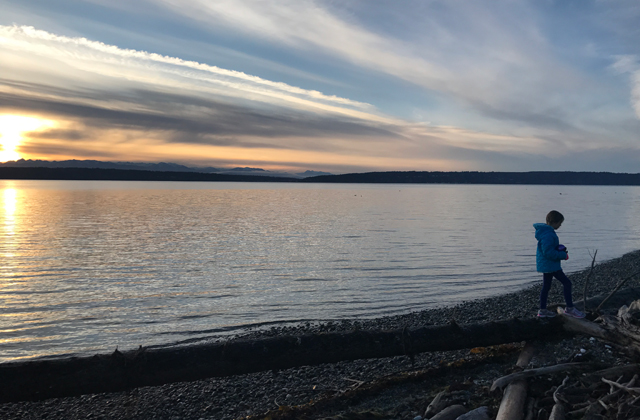 kid on beach at sunset