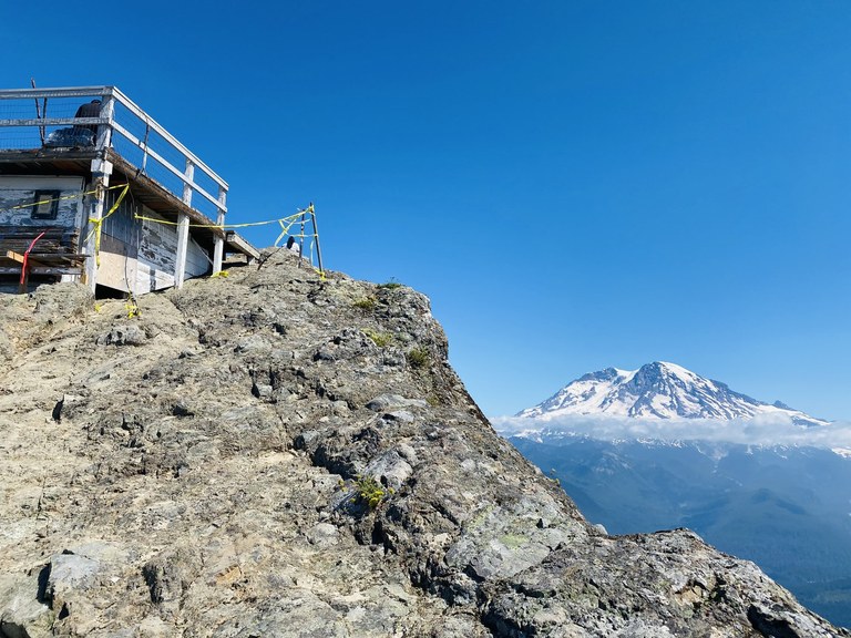 The wooden lookout tower at High Rock partially disassembled, with caution flagging surrounding the base.