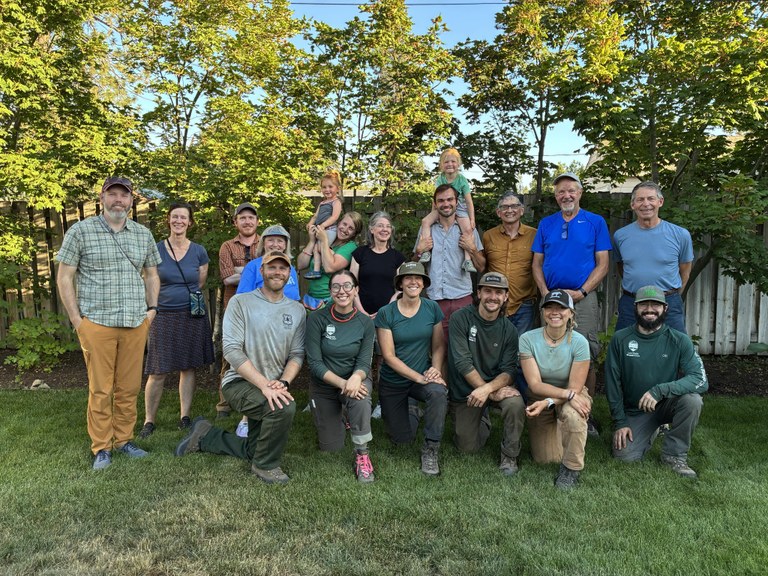 Step by step, advocates from Friends of the Bluff and professional trail maintainers came together to see this project through. Photo by Joe Hall A group of trail advocates pose for a photo on a lawn.