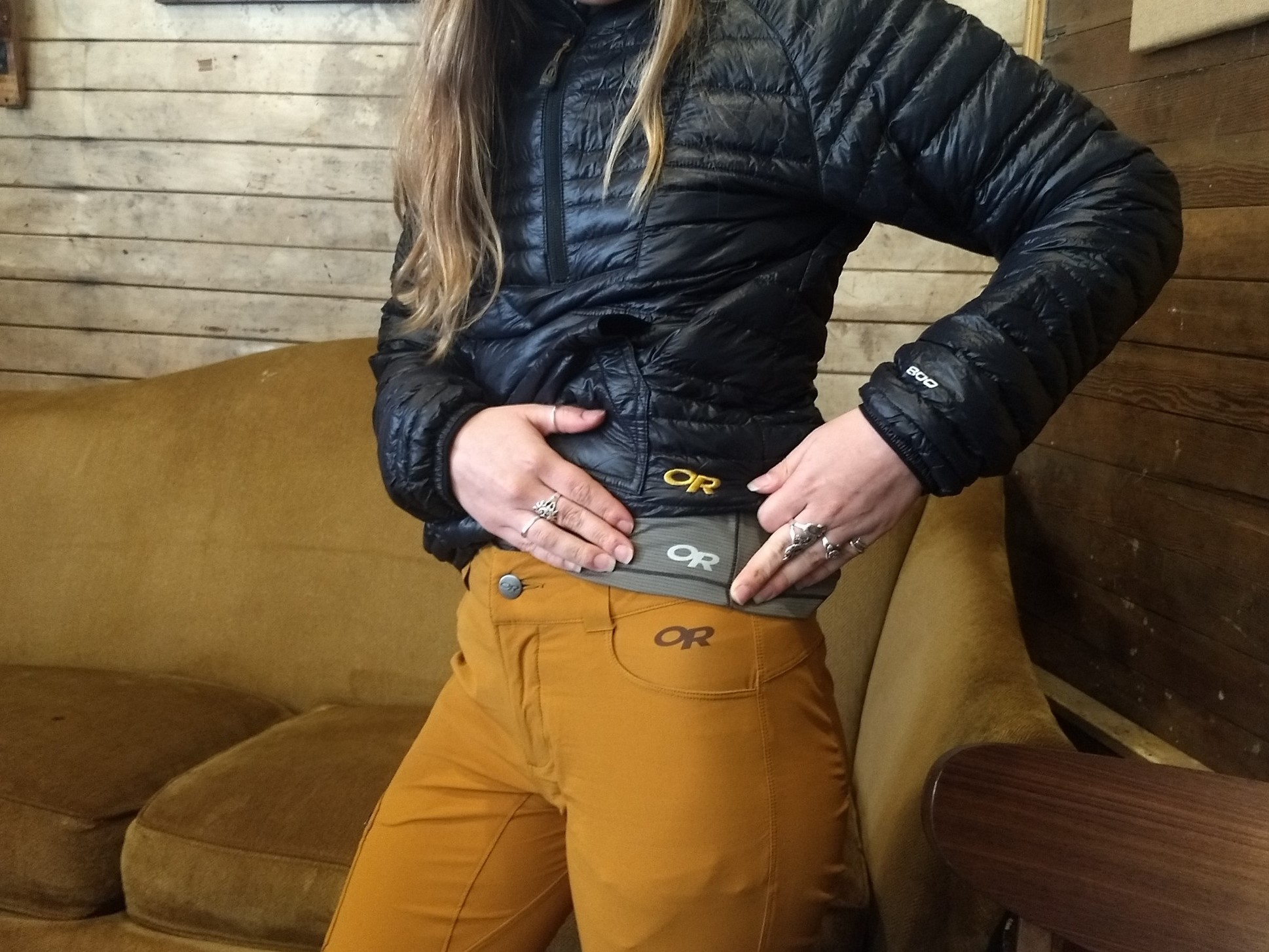 Brand loyalty at its finest. A hiker is dressed in layers of outdoor gear -- technical pants, a baselayer and puffy.