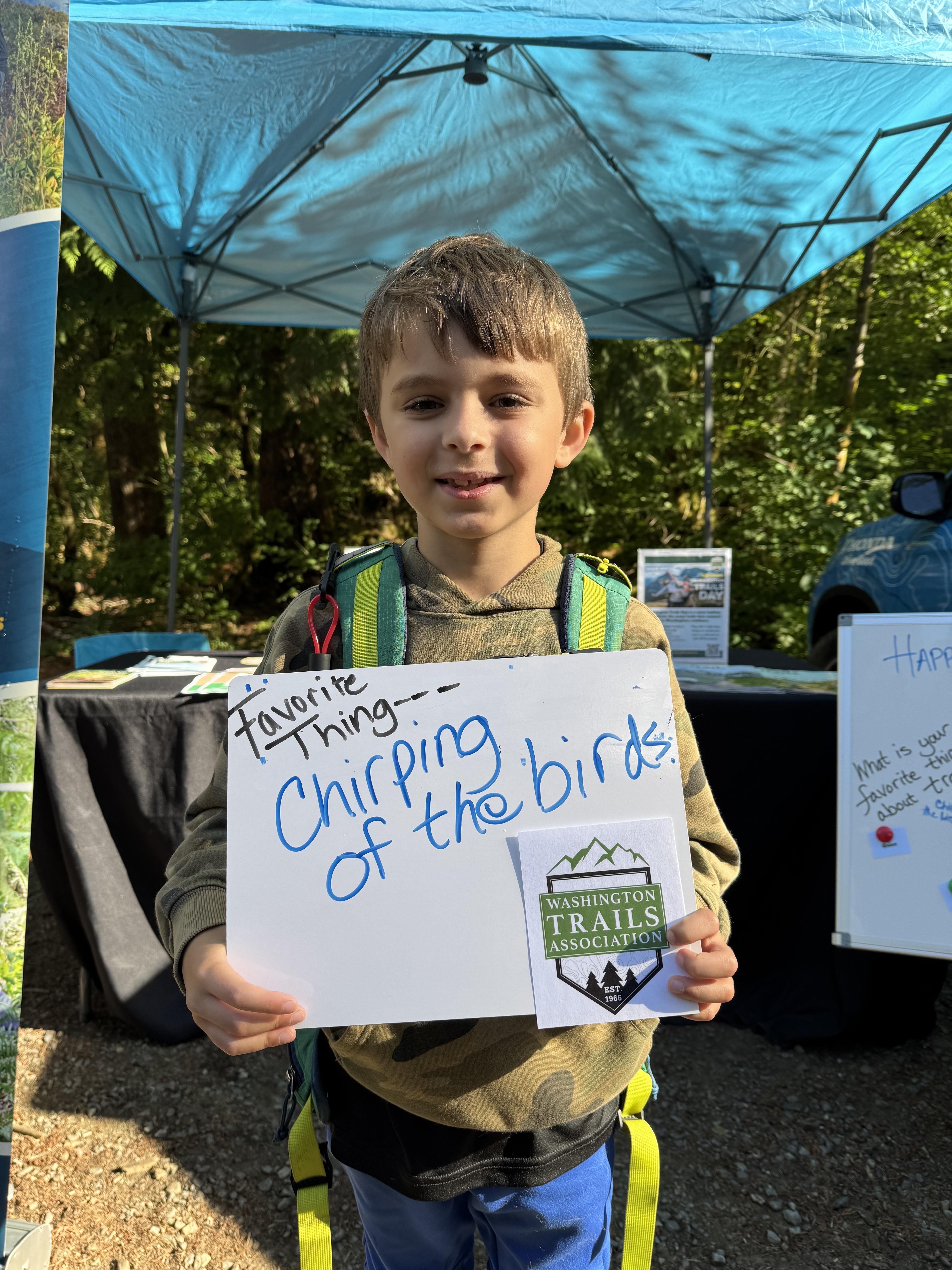 Kid holding sign that says his favorite thing is chirping of the birds Kid holding sign that says his favorite thing is chirping of the birds