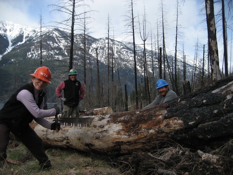 Pat Limberg and other volunteers use saws to clear trails in the backcountry.
