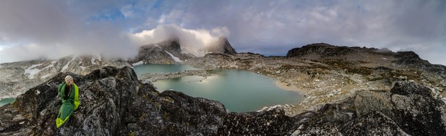 A backpacker greets the chilly dawn at Isolation Lake along Washington's Enchantment Lakes trail. Photo by Daniel Silverberg.