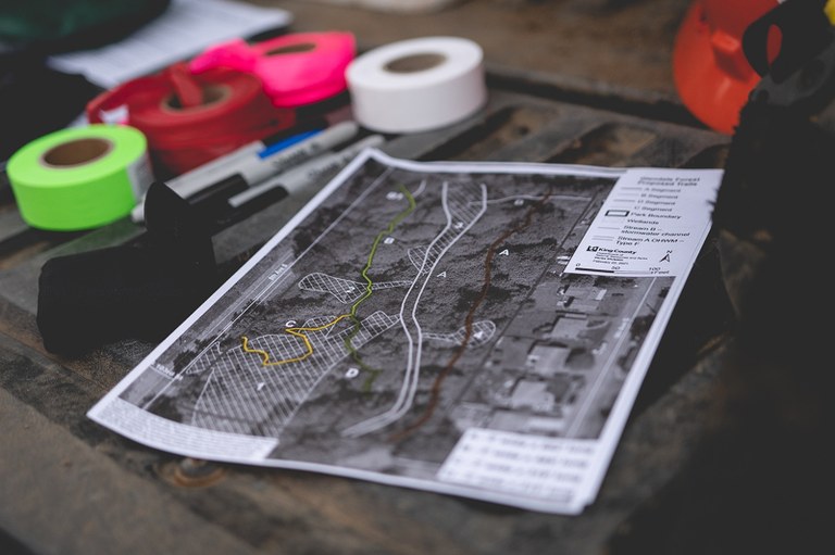 The tools of trail layout and design, plans and lots of flagging materials!