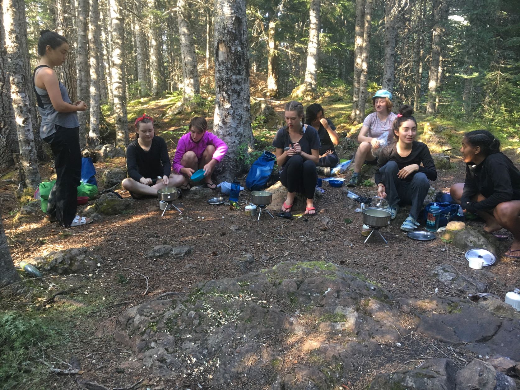 Students from Lake Washington Girls Middle school cooking a meal on a camping trip. Photo by Christine Zarker Primomo.