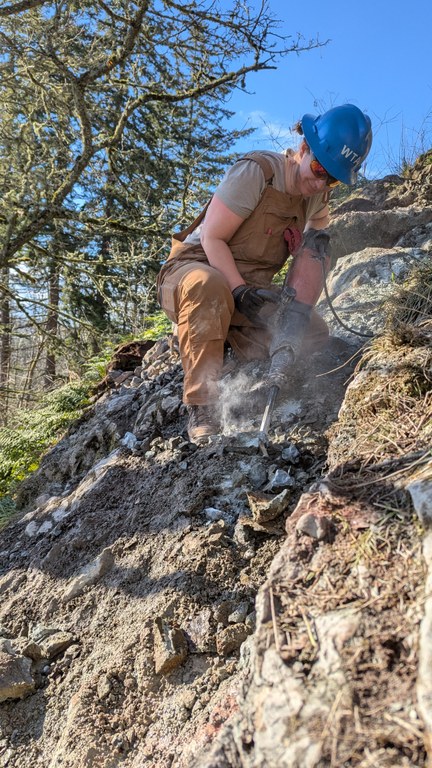 Crew leader Kesia Lee works on the trail using a jackhammer. Photo courtesy Kesia Lee.