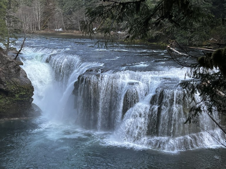 Lewis River Falls A wide waterfall cascades down into a pool below.