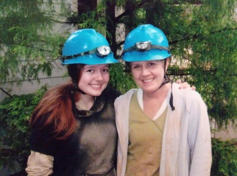 Linnea with her mother wearing helmets after spelunking in a cave. Photo by Linnea Johnson.