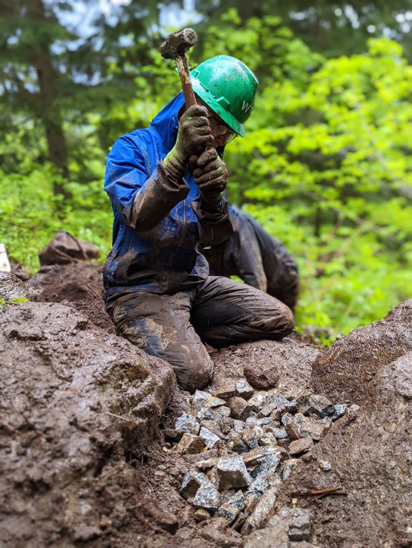 Breaking down rocks with a sledgehammer. Photo by Zachary Toliver.