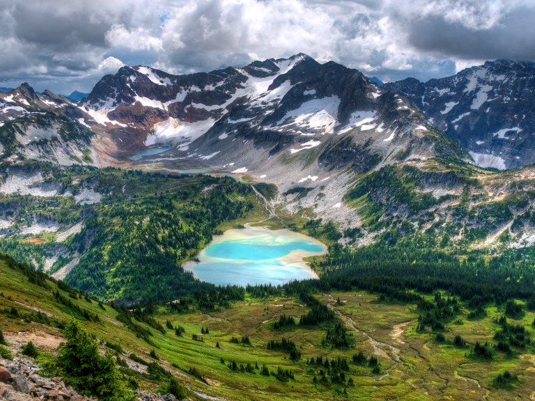 A view of bright blue lakes from atop a nearby peak