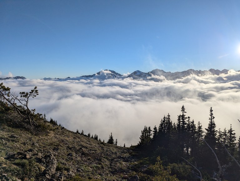 Peaks peeking over the clouds from Marmot Pass. Photo by kinira.