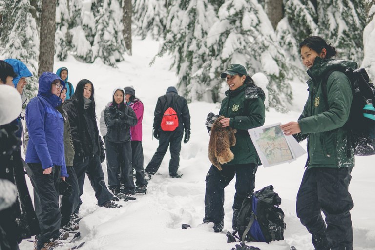 Aleta Eng (center) and Kelsey Chun teach InterImWILD about how animals adapt to winter. Photo by Britt Le 