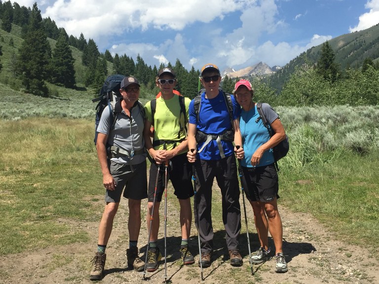 Jake and family on a hike together, smiling at the camera in front of a beautiful valley. Jake and family on a hike together, smiling at the camera in front of a beautiful valley.