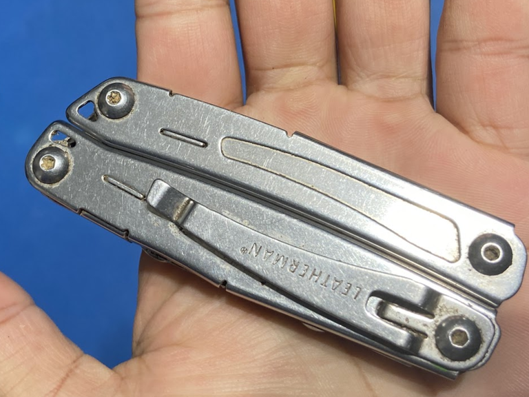 A leatherman multitool in the palm of a hand.