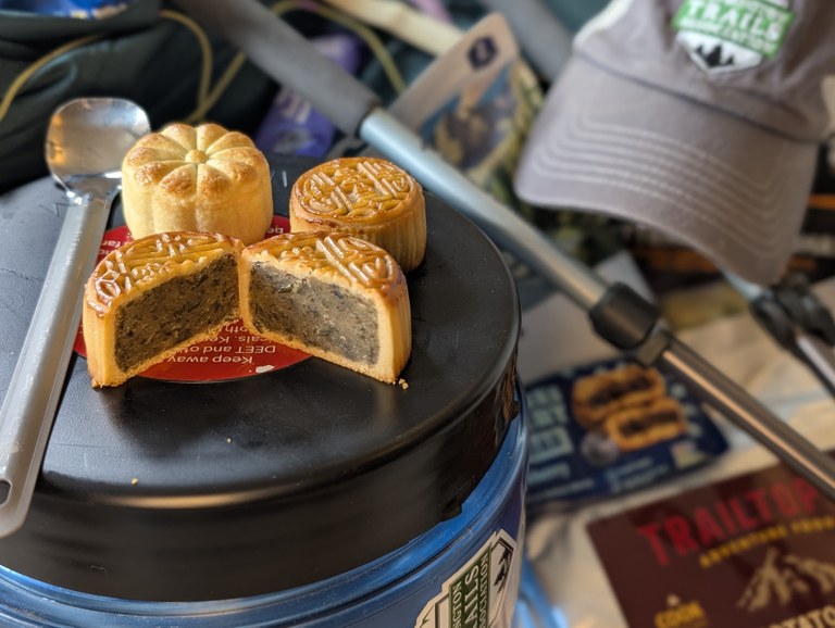 Mooncakes on a bear canister, amongst other hiking gear and backpacking meals. Photo by Tiffany Chou.