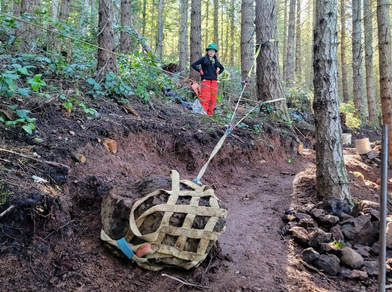 Volunteer standing at rigging watching move a large rock. Photo by Eric Nagle. Volunteer standing at rigging watching move a large rock. Photo by Eric Nagle.