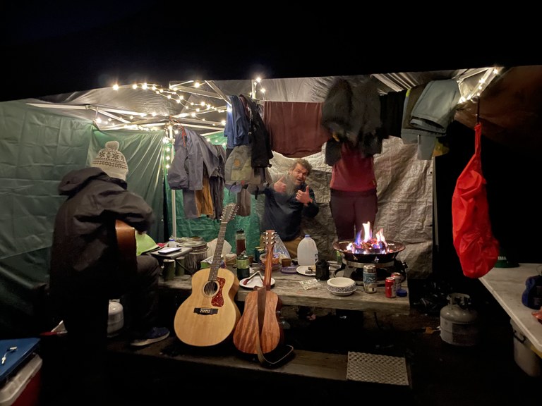Mount Pilchuck BCRT. Photo by Brandon Tigner. Crew members under a tarp/tent in the rain drying out clothes and other things. Photo by Brandon Tigner.