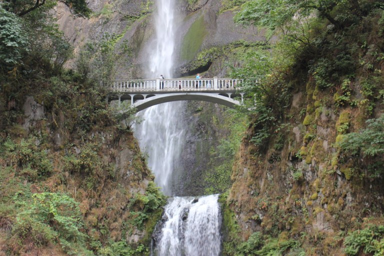 Bridge over Multnomah Falls with people standing on it. Photo by viji133hp.