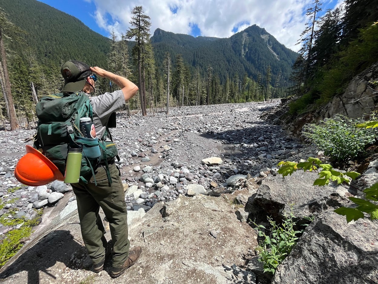 National Park Service trail crew - member assessing damage near the Lower Crossing of the Carbon River.