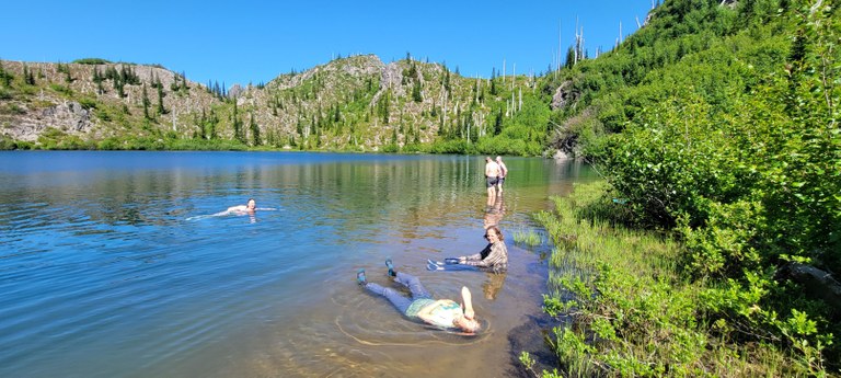 Panhandle Lake BCRT. Photo by James Alexander. Crew members taking a dip in Panhandle Lake on a backcountry response team work party. Photo by James Alexander.