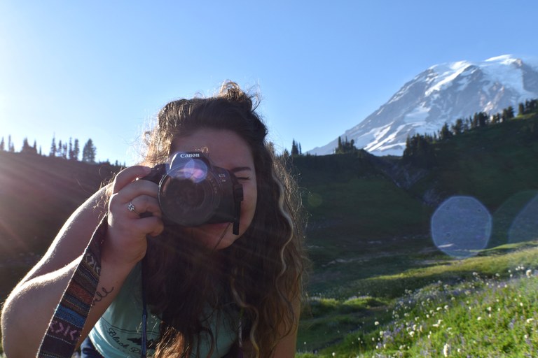 A photographer at Mount Rainier looks at the camera. Photo by Morgan Henderson.