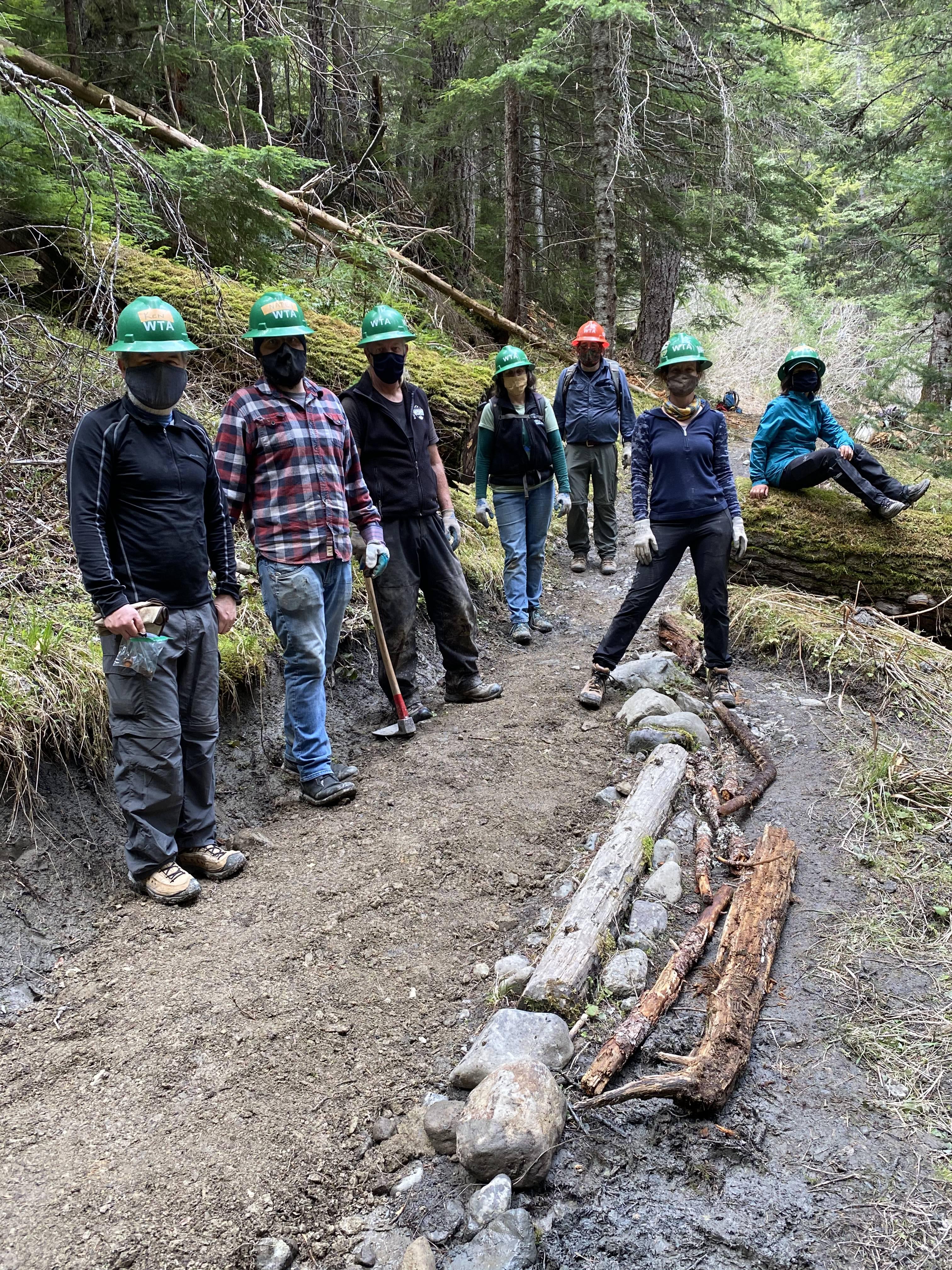 Volunteers pose on a newly constructed turnpike on the Upper Dungeness trail.
