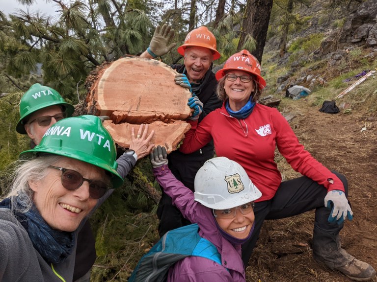 Volunteer Vacation crew taking a selfie next to a log. Photo by Karin Plagens.