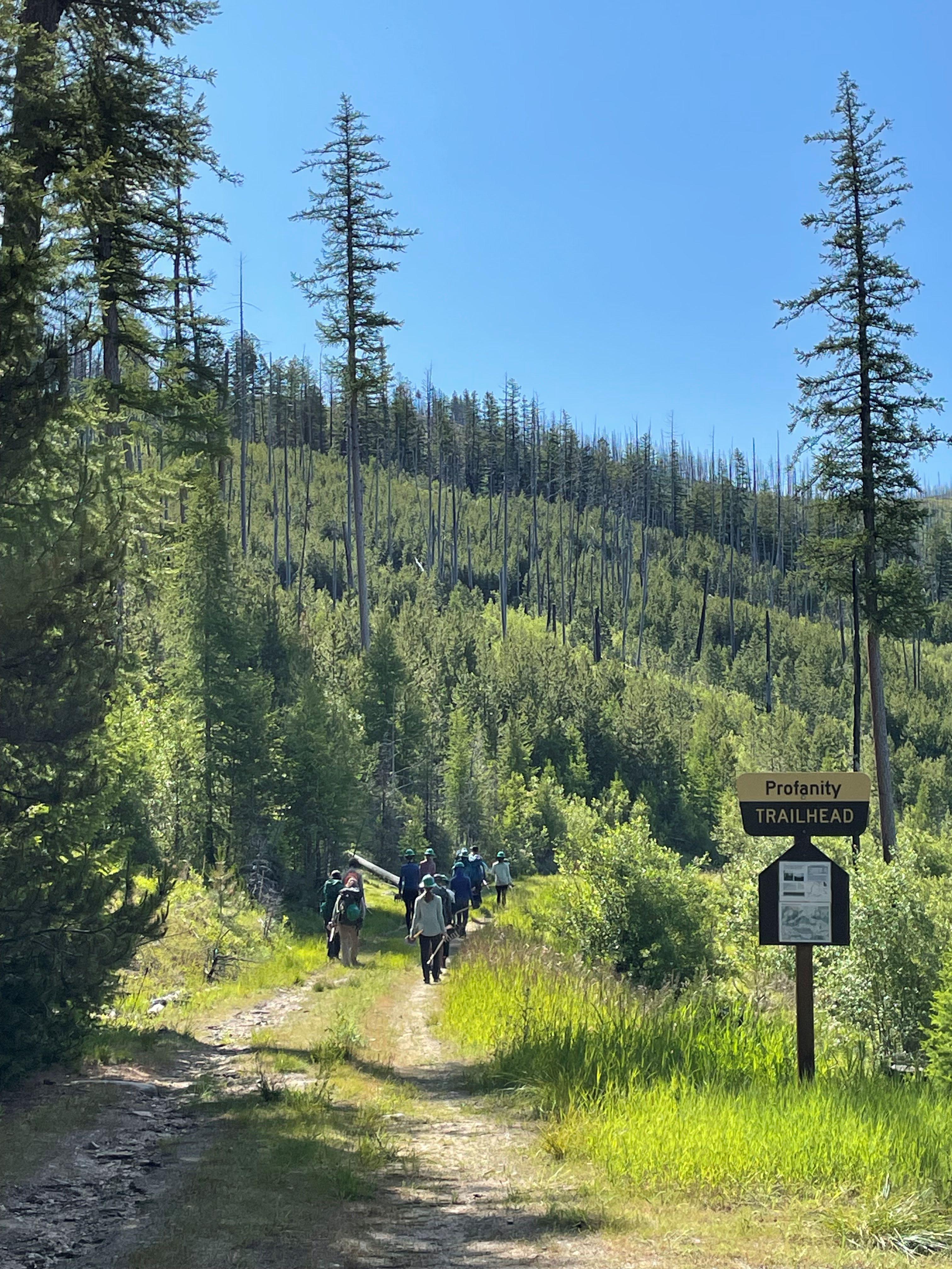 Trail work volunteers from the Saint George's School hike in on the Profanity Trail with tools. Photo by Holly Weiler.