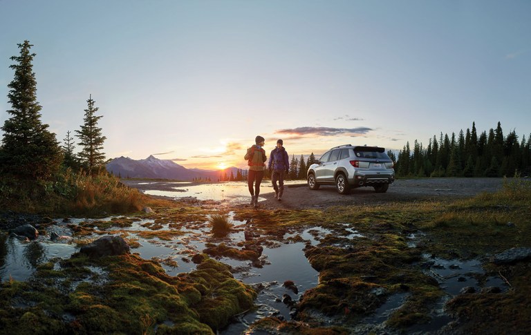 Photo Two hikers next to a Honda vehicle. Photo by Western Washington Honda Dealers.
