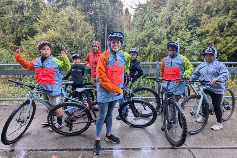 Seven bikers pose with their bikes