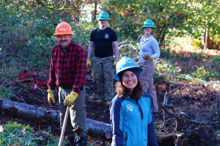 A volunteer crew smiles at the camera during a day of work at Ridgefield.