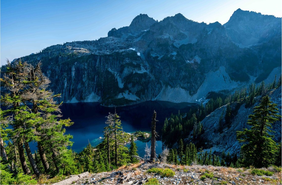 Lake nestled in a rocky basin on a sunny day