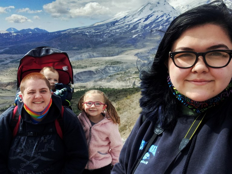 Two adults and two kids at Mount St. Helens. 