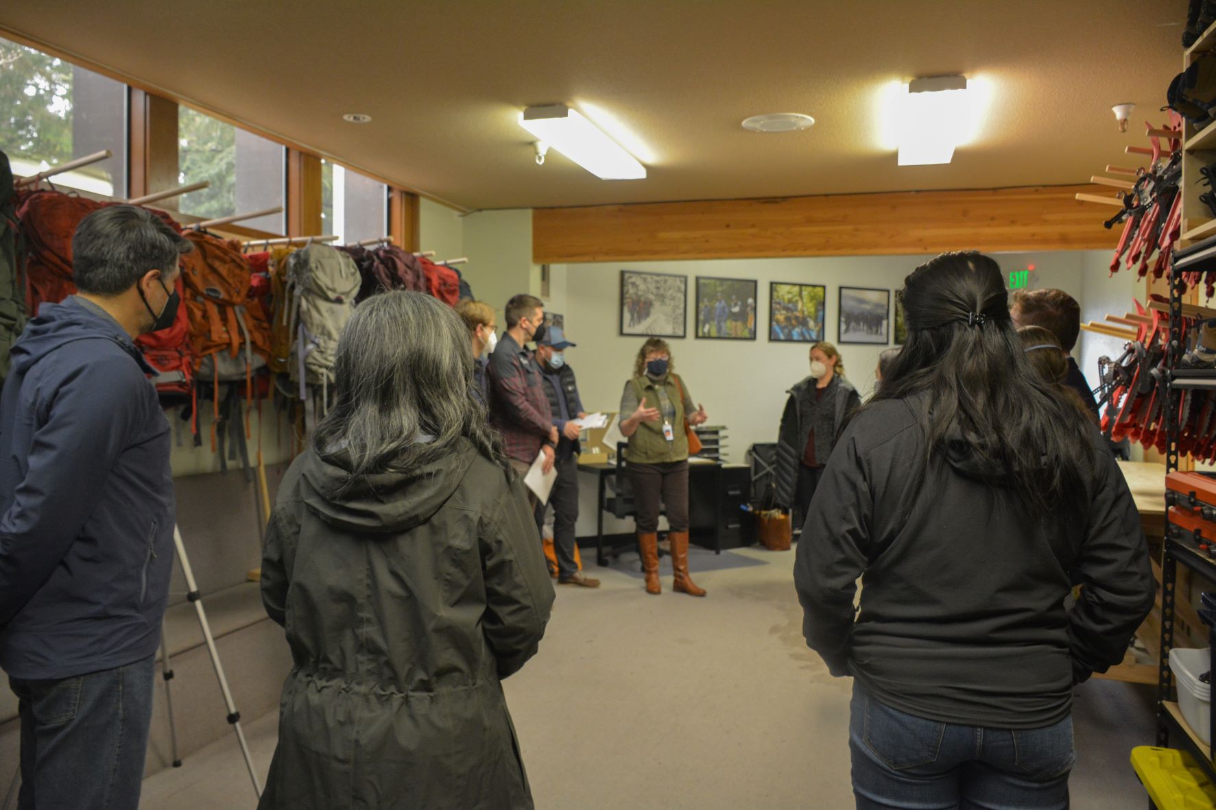 People stand and talk in a circle at WTA's gear library.
