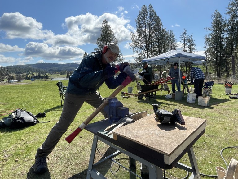 tool work3 Holly Weiler.JPG A volunteer uses a grinder to sharpen a pulaski.